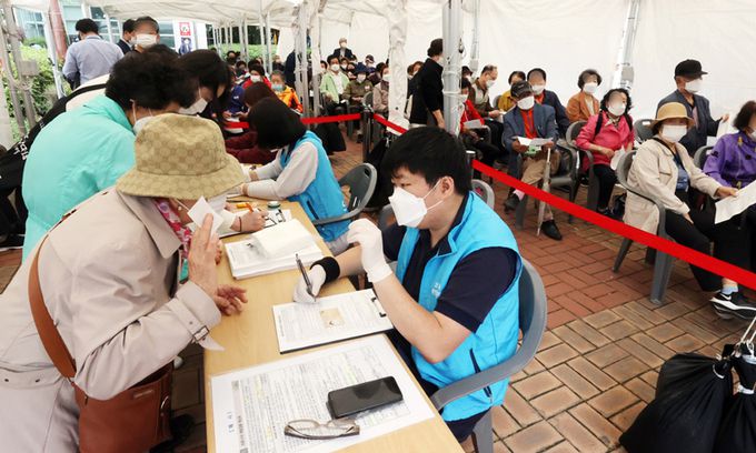 지난달 31일 서울 구로구보건소에서 어르신들이 화이자 백신을 접종받기 위해 예진표를 작성하고 있다. 연합뉴스