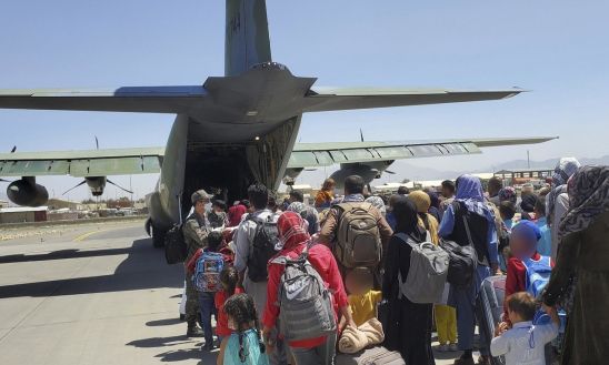 국내 이송이 결정된 아프가니스탄인들이 25일(현지시간) 카불 공항에서 공군 C-130J '슈퍼 허큘리스' 수송기에 탑승하기 위해 대기하고 있다. 공군 제공