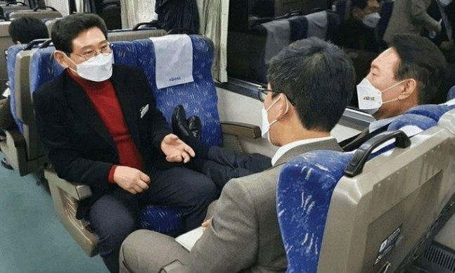 국민의힘 이상일 대선 후보 상근보좌역이 13일 사회관계망서비스(SNS)에 올린 전날 ‘열정열차’ 내부 사진들 중 여권의 뭇매를 맞은 사진. 윤석열 후보(오른쪽 첫번째)가 맞은편 빈 좌석에 구둣발을 올려놓고 있다. 페이스북 캡처