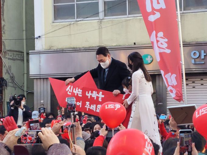 국민의힘 윤석열 대선 후보가 27일 오후 '윤석열이 영일만의 친구가 되겠습니다' 포항 유세를 마친 뒤 한 어린이로 부터 '신나는 나라를 만들어 주세요'라고 적힌 팻말을 전달받고 있다.