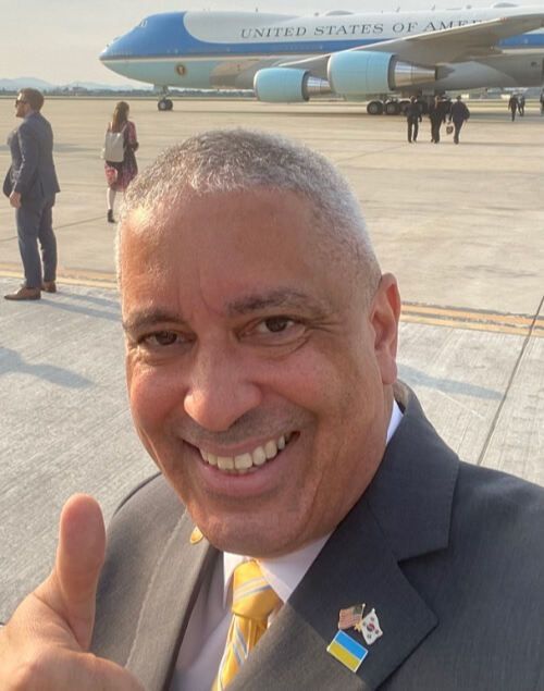 크리스 델코소 주한 미국 대사대리가 조 바이든 미국 대통령의 방한 첫날인 지난 20일 오산공군기지에 착륙한 미 대통령 전용기 ‘에어포스원’을 배경으로 인증사진을 찍는 모습. 델코소 대사대리 SNS 캡처