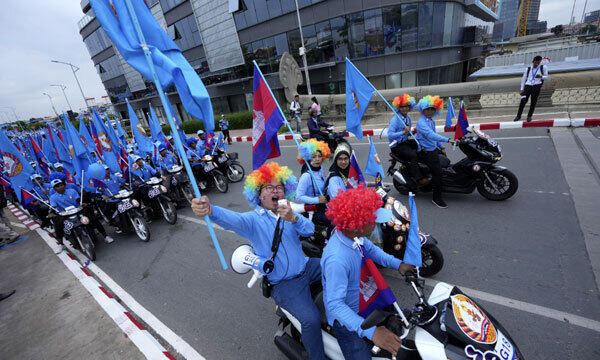 총선을 이틀 앞둔 21일 캄보디아 프놈펜에서 캄보디아인민당 선거 운동원들이 오토바이를 타고 지지를 호소하고 있다. 프놈펜=AP연합뉴스