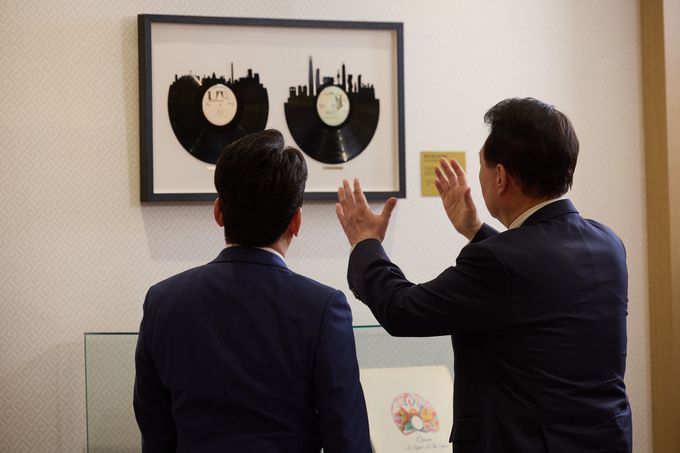 윤석열 대통령이 지난 4일 서울 용산 대통령실 청사에서 가진 KBS '특별대담 대통령실을 가다' 녹화를 마친 뒤 박장범 KBS 앵커에게 지난해 4월 미국 국빈 만찬 시 토니 블링컨 미 국무장관이 증정한 레코드판을 소개하고 있다. 연합뉴스