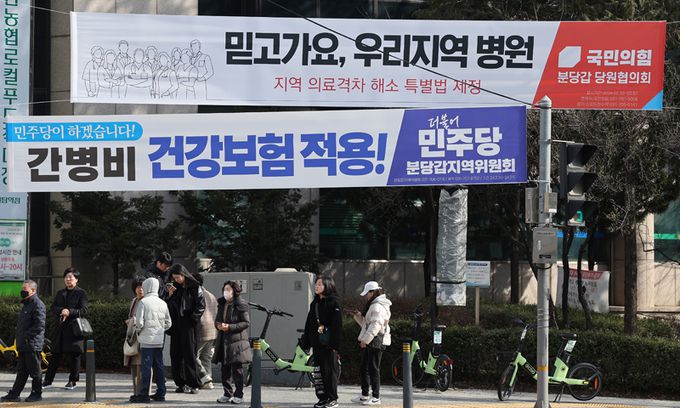 ‘경기권 최대 격전지’로 부상 국민의힘 안철수 의원 대 더불어민주당 이광재 전 국회 사무총장 간 빅매치가 성사되면서 새로운 총선 격전지로 떠오른 경기 성남 분당갑 지역구의 야탑동 야탑사거리에 27일 양당 정책을 홍보하는 현수막이 걸려 있다.  성남=남정탁 기자