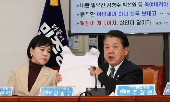 더불어민주당 김병주 최고위원(오른쪽)이 22일 국회에서 열린 최고위원회의에서 방검복을 들고 발언하고 있다. 연합뉴스