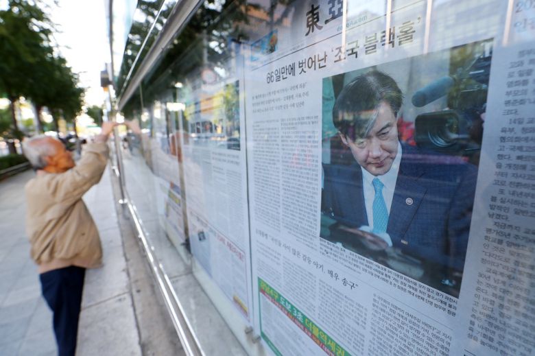 2019년 10월 15일 서울 종로구 세종대로사거리 일대에서 한 시민이 조국 전 법무부장관 관련 기사를 살펴보고 있다. 조 전 장관은 가족 관련 사모펀드와 입시 비리 논란 등으로 취임 35일 만에 전격 사퇴했다. 뉴시스