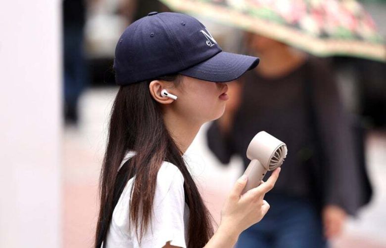 대구 중구 동성로에서 한 시민이 손 선풍기를 들고 길을 걷고 있다. 뉴시스