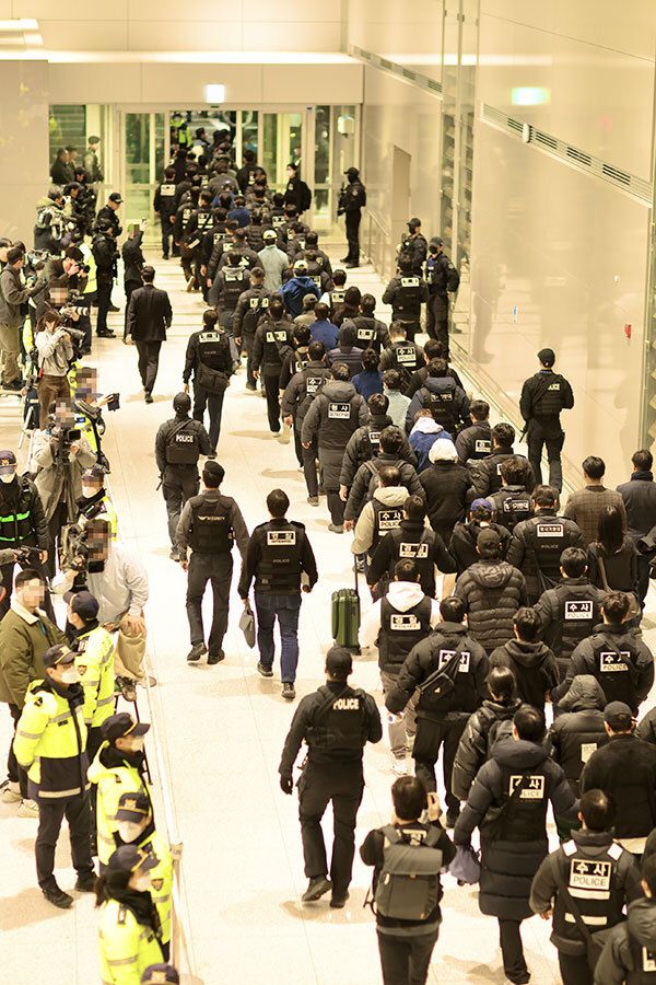 부산경찰이 23일 오전 인천공항을 통해 강제 송환된 캄보디아 범죄단체 가담자 73명 중 49명을 부산으로 압송하고 있다. 부산경찰청 제공