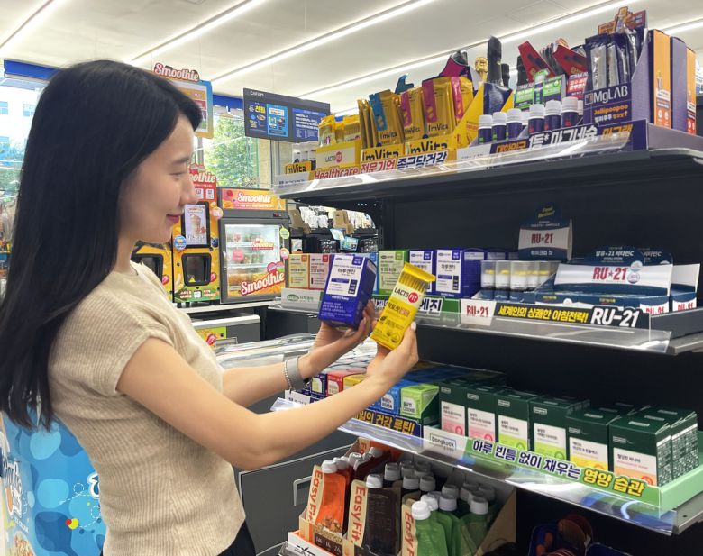 GS25 매장에서 모델이 건기식 상품들을 살펴보고 있다. GS리테일 제공