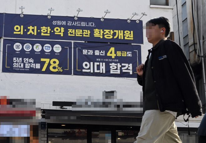 서울의 학원가에 의대반 모집을 알리는 홍보물 앞을 시민이 지나고 있다. /송의주 기자