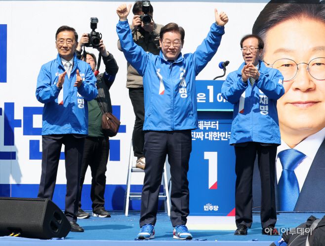 이재명 더불어민주당 대선 후보가 6·3 대통령선거 공식 선거운동 첫날인 12일 서울 광화문 청계광장에서 열린 출정식 및 첫 유세에서 운동복과 운동화를 전달받은 뒤, 손을 번쩍 들고 있다. /송의주 기자