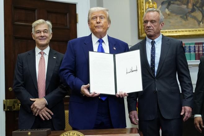 도널드 트럼프 미국 대통령(가운데) 12일(현지시간)이 백악관 루즈벨트룸에서 의약품 가격 인하 관련 행정명령에 서명한 후 메흐메트 오즈 메디케어·메디케이드 서비스센터(CMMS) 센터장(왼쪽)과 로버트 F. 케네디 주니어 보건복지부 장관 등과 기념사진을 찍고 있다./EPA·연합