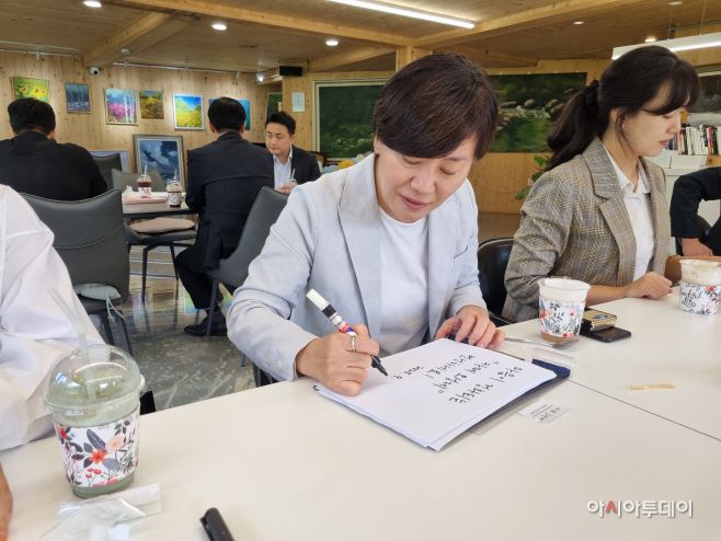 송미령 농림축산식품부 장관이 18일 전북 완주군 소양면 '오성한옥마을'에 위치한 카페에서 방명록을 남기고 있다. /정영록 기자