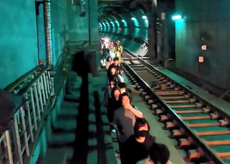 지난 31일 오전 서울 지하철 5호선 여의나루-마포역 구간에서 방화로 인한 화재가 발생해 승객들이 열차에서 내려 선로를 통해 대피하고 있다.  서울 영등포소방서가 제공한 영상에는 승객들이 선로를 따라 한 줄로 질서 있게 걸으며 대피하는 모습이 담겼다. 일부 승객들은 휴대전화 손전등으로 앞쪽을 비추며 안내하며 서로를 도왔다. 2025.06.01 영등포소방서 제공