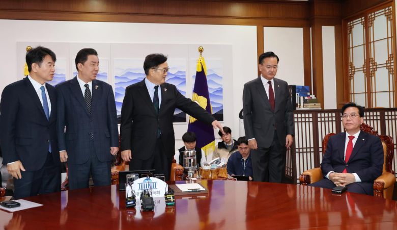 우원식 국회의장이 27일 오전 서울 여의도 국회에서 열린 여야 원내대표 회동에 참석해 사진촬영을 거부하는 송언석 국민의힘 원내대표에게 참여를 권하고 있다. 뉴시스