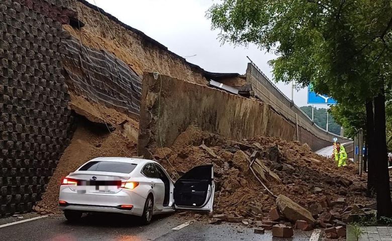 지난해 7월 16일 경기 오산시 가장교차로 고가도로 옹벽이 무너져 차량이 깔려 있다. 40대 운전자는 숨졌다. 해당 옹벽은 사고 전 정밀안전점검에서 양호 판정을 받았으나, 조사 결과 보고서에 예전 사진을 재사용하는 등 부실 점검 정황이 드러났다. 경기소방재난본부 제공