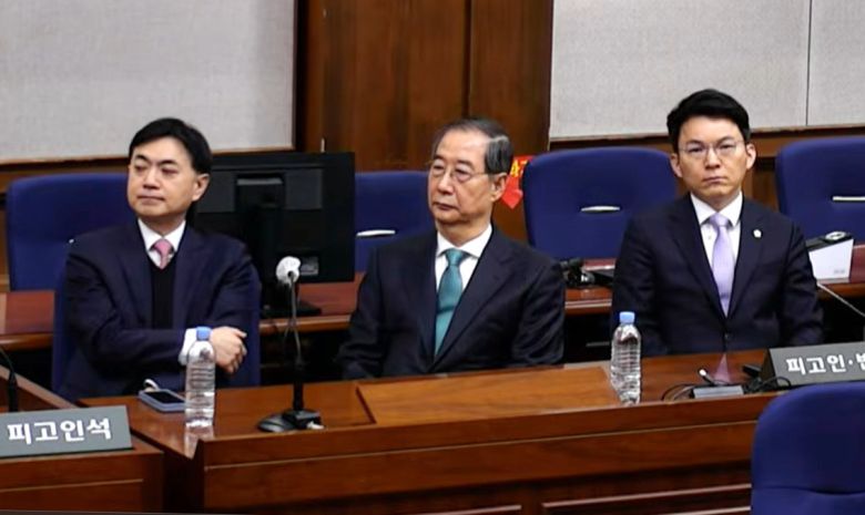 한덕수 전 국무총리가 21일 서울중앙지법에서 열린 내란 우두머리 방조와 내란 중요임무종사 혐의에 대한 1심 선고 재판에 참석해 재판장의 발언을 듣고 있다. 서울중앙지법 재판 중계 화면 캡처