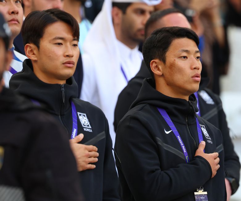 20일(현지시간) 카타르 도하 앗수마마 스타디움에서 열린 2023 아시아축구연맹(AFC) 카타르 아시안컵 조별리그 E조 2차전 요르단과 한국의 경기에 앞서 대표팀 김진수와 황희찬이 관중석에서 애국가를 부르고 있다.(연합뉴스)
