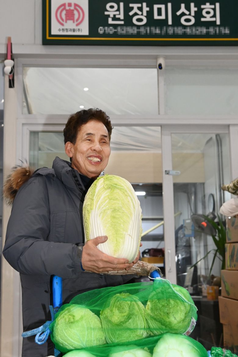 이재호 수원청과 채소중도매인 조합장이 배추를 들어 보이고 있다.