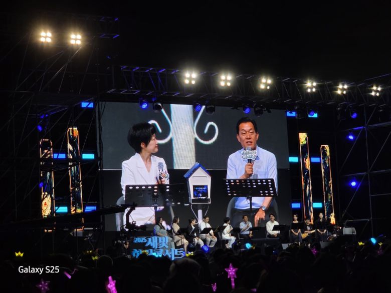 이재준 수원특례시장이 13일 수원컨벤션센터에서 열린 2025 새빛 힐링콘서트 무대에 올라 마이크를 들고 시민 봉사자들을 위한 헌정의 시간을 진행하고 있다.