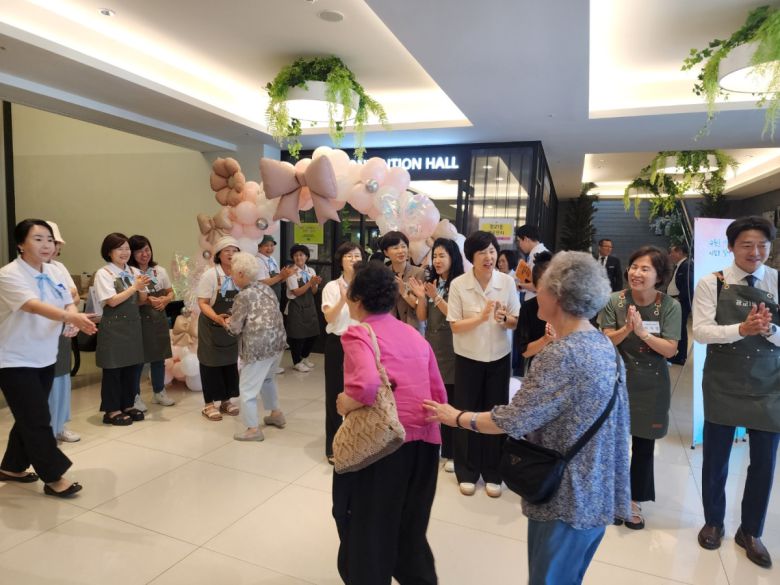 수원특례시 영통구 광교1동 경로잔치에 참석한 주민들이 풍선 아치 앞에서 박수로 행사를 환영하고 있다.