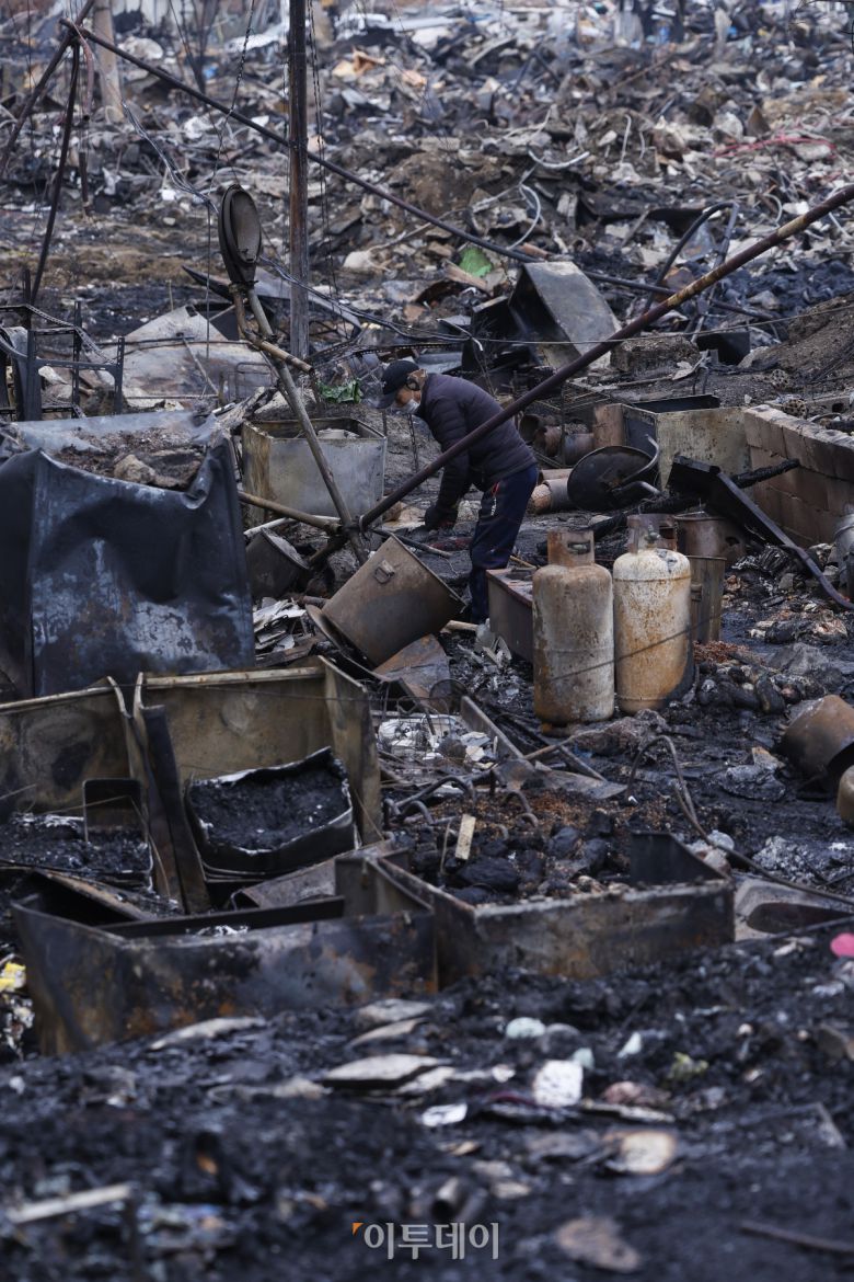18일 서울 강남구 개포동 구룡마을 화재 현장에서 한 주민이 불에 탄 잔해 속 물품을 정리하고 있다. 16일 오전 5시쯤 구룡마을 4지구에서 발생한 화재로 소방당국은 대응 2단계를 발령해 6시간 30여 분만에 불을 진화했다. 이 과정에서 소방 343명과 경찰 560명 등 인력 1258명과 장비 106대가 투입됐다. 인명 피해는 없었으나 165세대 258명이 대피했고, 이 중 129세대 181명이 이재민이 됐다. 관계 당국은 19일 합동 감식에 나설 예정이다. 조현호 기자 hyunho@
