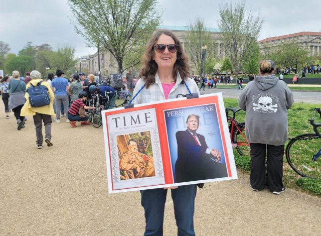 ▲5일(현지시간) 도널드 트럼프 미국 대통령의 일방주의적 국정 운영에 반대하는 시위가 워싱턴 DC 내셔널 몰에서 열리고 있다. 한 참가자가 트럼프 대통령과 히틀러(1938년)를 각각 '올해의 인물'로 선정한 시사주간 타임지 표지 2개를 나란히 배치한 팻말을 목에 건 채 포즈를 취하고 있다. ⓒ연합뉴스