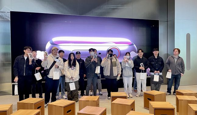 13일 사전 예약을 통해 아이폰15를 가장 빠르게 구매한 15인이 기념 사진 촬영을 하고 있다,/사진=백유진 기자 byj@