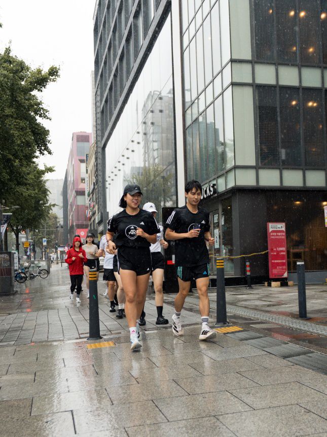 페이서를 따라 빗속을 달리고 있는 참가자들/사진=아디다스