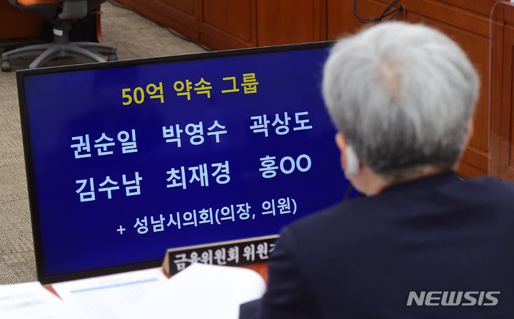 [서울=뉴시스] 전신 기자 = 고승범 금융위원장이 6일 서울 여의도 국회에서 열린 정무위원회의 금융위원회의 국정감사에서 박수영 국민의힘 의원이 공개한 대장동 개발사업 의혹 관련 '50억원 약속 그룹' 명단을 바라보고 있다. (공동취재사진) 2021.10.06. photo@newsis.com