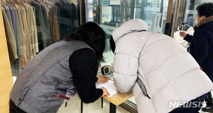 [인천=뉴시스] 이루비 기자 = 10일 오전 인천 계양구 한 대형마트에서 10대 남학생이 수기명부를 작성하고 있다. 2022. 1.10. ruby@newsis.com