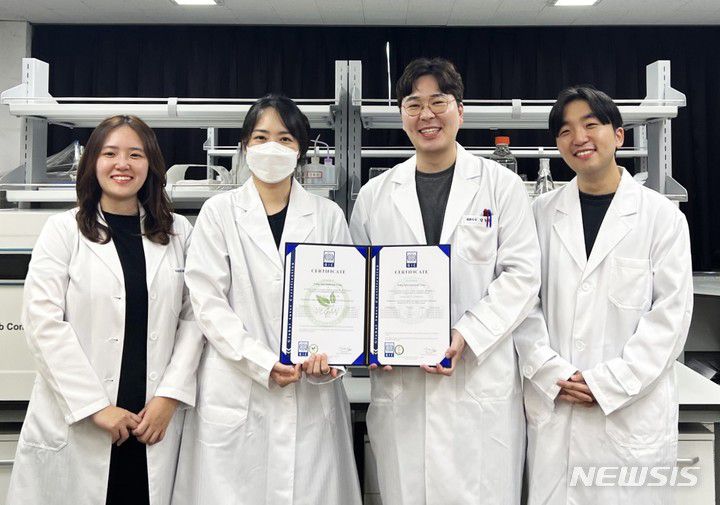 [창원=뉴시스] 홍정명 기자= 경남 양산 소재 ㈜양인터네셔널 양동완(오른쪽 두 번째) 대표와 연구진이 '비건 인증서'를 들고 기념촬영하고 있다.(사진=경남창조경제혁신센터 제공)2022.10.01. photo@newsis.com