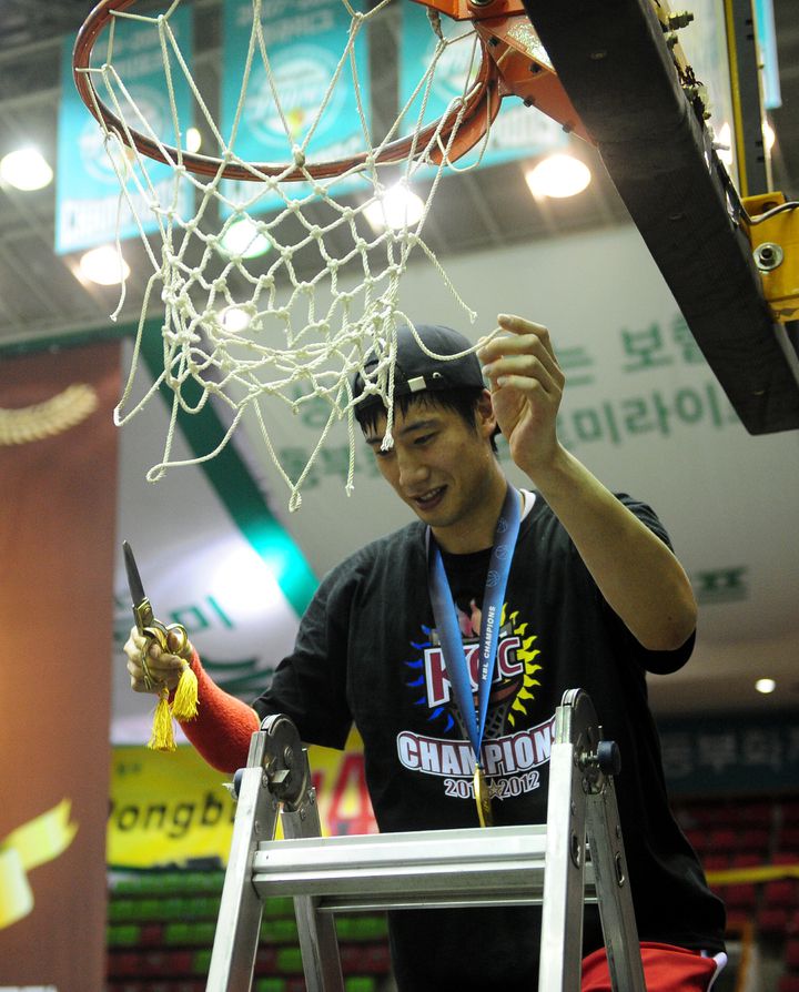 [안양=뉴시스]6일 오후 원주치악체육관에서 열린 2011~2012 KB국민카드 프로농구 챔피언결정전 6차전 원주 동부 프로미와 안양 KGC 인삼공사의 경기에서 66대 64로 승리하며 구단 창단 첫 우승을 차지한 KGC인삼공사 양희종이 우승그물망을 자르고 있다. 2012.04.06. (사진 = 뉴시스DB) *재판매 및 DB 금지
