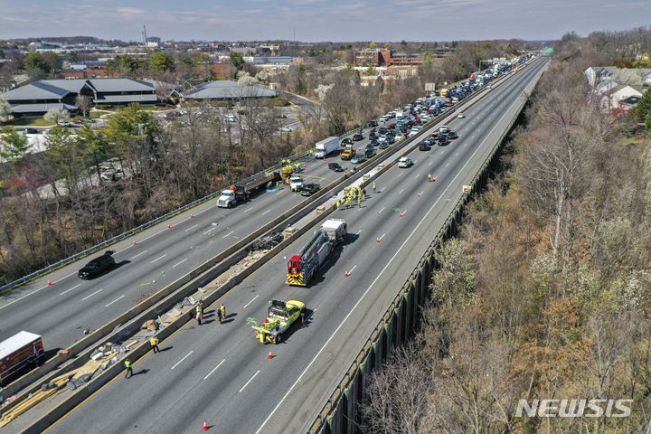 Emergency personnel work at the scene of fatal crash along Interstate 695 near Woodlawn, Md., Wednesday, March 22, 2023. At least six people were dead after a crash that closed the Baltimore Beltway in both directions Wednesday, snarling traffic along the west side of the highway that encircles the city, Maryland State Police said. (Jerry Jackson/The Baltimore Sun via AP)