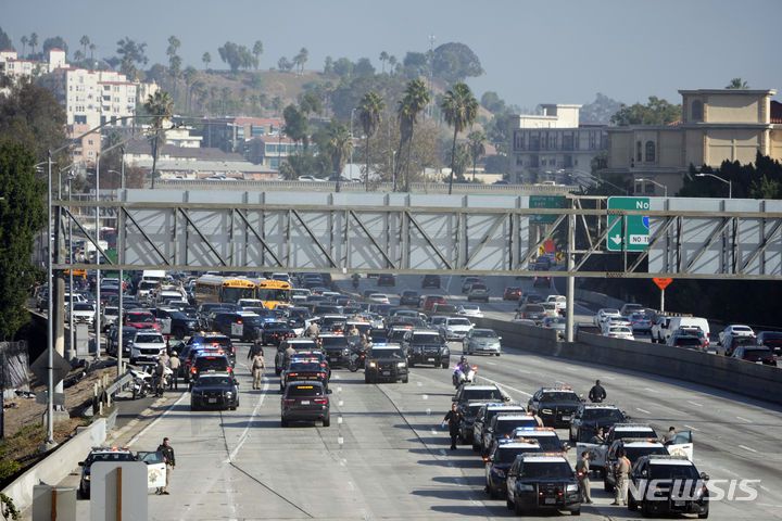 Police state on the 110 freeway after pro-Palestinian protesters blocked in during the morning commute Wednesday, Dec. 13, 2023, in Los Angeles. (AP Photo/Marcio Jose Sanchez)