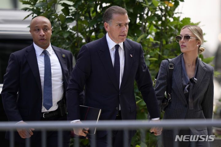 [AP/뉴시스] 조 바이든 대통령의 차남 헌터 바이든이 3일 자신의 총기불법 구입 연방재판에 출두하기 위해 부인과 함께 델라웨어주 윌밍턴 법원으로 가고 있다