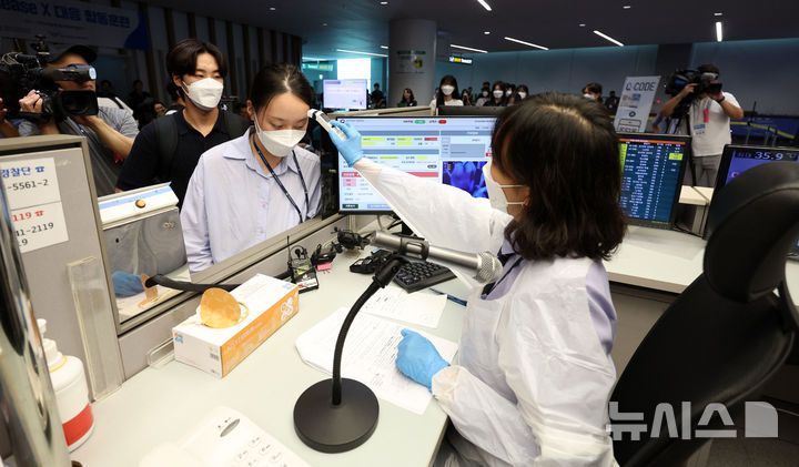 [인천공항=뉴시스] 김선웅 기자 = 지난해 9월3일 인천국제공항 제2여객터미널에서 열린 해외유입 Disease X 대응 합동 훈련에서 국립인천공항검역소 관계자가 승객에 대한 검역을 진행하고 있다. 2024.09.03. mangusta@newsis.com