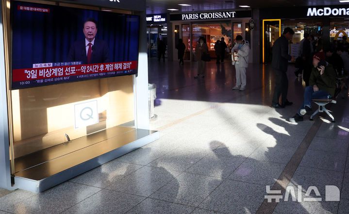 [서울=뉴시스] 추상철 기자 = 7일 오전 서울 용산구 서울역에서 시민이 윤석열 대통령의 대국민 담화 TV를 시청하고 있다. 2024.12.07. scchoo@newsis.com