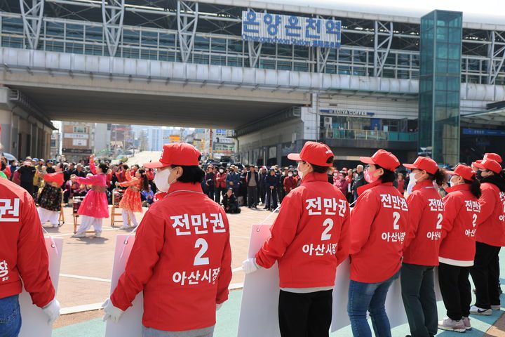 [아산=뉴시스] 박우경 기자=2025년 상반기 재보궐선거 공식 선거운동일인 20일 충남 아산시장 재선거에 출마한 여야 후보 캠프 관계자들이 온양온천역 광장 앞에서 유권자들의 지지를 호소하고 있다. 2025.3.20. spacedust1@newsis.com *재판매 및 DB 금지