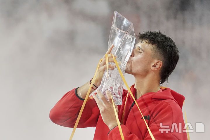 [마이애미=AP/뉴시스] 야쿱 멘식(54위·체코)이 30일(현지 시간) 미 플로리다주 마이애미가든에서 열린 남자프로테니스(ATP) 마이애미 오픈 단식 정상에 올라 트로피를 들고 입 맞추고 있다. 올해 19세인 멘식은 결승전에서 투어 레벨 통산 100승을 노리던 노바크 조코비치(5위·세르비아)를 2-0(7-6 7-6)으로 꺾고 정상에 올랐다. 2025.03.31.