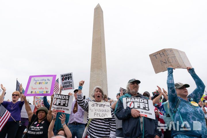 [워싱턴=AP/뉴시스] 5일(현지 시간) 미국 워싱턴 워싱턴기념비 앞에서 도널드 트럼프 대통령과 일론 머스크 정부효율부 수장에 반대하는 '핸즈 오프!'(Hands Off!) 집회가 열려 참가자들이 구호를 외치고 있다. 이날 미국 전역에서 손을 떼라는 의미의 '핸즈 오프' 시위와 행진이 열려 시민권 단체, 노동조합, 성소수자 권익 옹호 단체와 참전용사 단체 등이 참여했다. 2025.04.06.