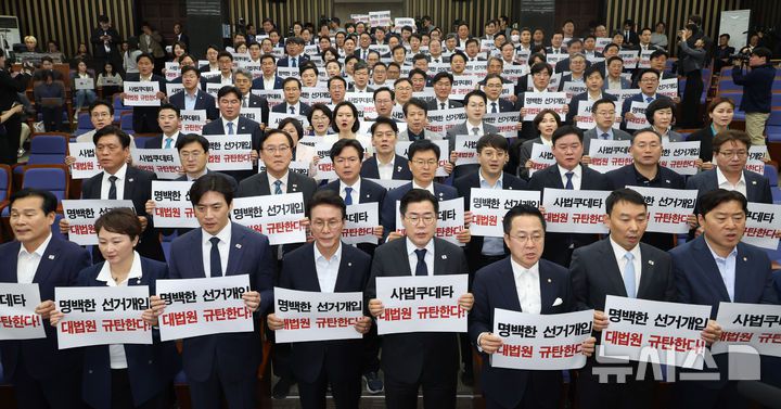 [서울=뉴시스] 조성봉 기자 = 박찬대 더불어민주당 대표 직무대행 겸 원내대표와 의원들이 1일 오후 서울 여의도 국회에서 열린 긴급 의원총회에서 손피켓을 들고 구호를 외치고 있다. 2025.05.01. suncho21@newsis.com