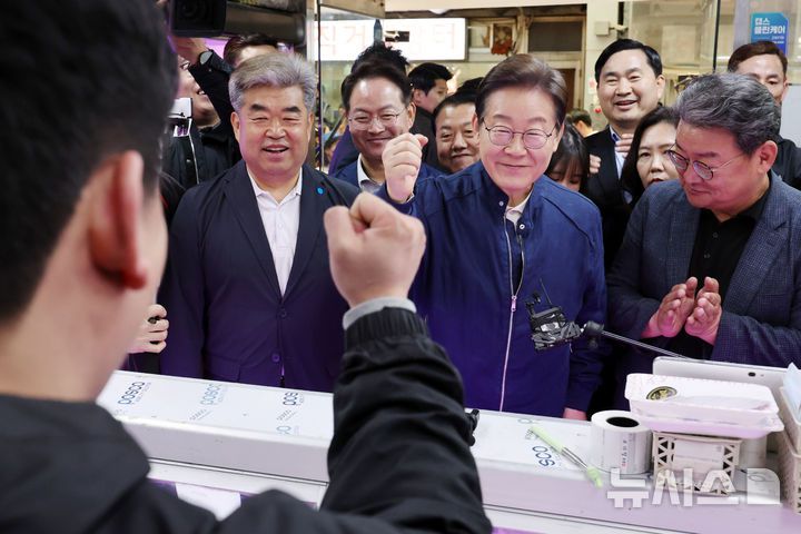 [철원=뉴시스] 조성우 기자 = 민심을 청취하는 '경청 투어'에 나선 이재명 더불어민주당 대선후보가 2일 오전 강원도 철원군 동송전통시장을 찾아 정육점 직원을 격려하고 있다. 2025.05.02. xconfind@newsis.com