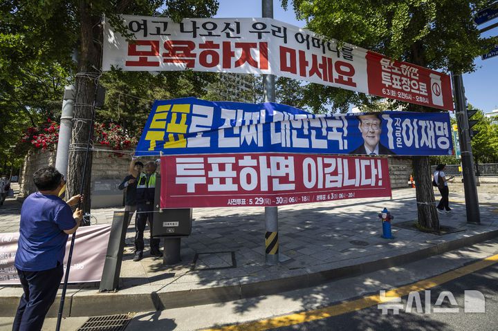 [서울=뉴시스] 정병혁 기자 = 제21대 대통령 선거가 끝난 4일 서울 종로구 광화문네거리에서 종로구청 관계자들이 선거 현수막을 철거하고 있다. 2025.06.04. jhope@newsis.com