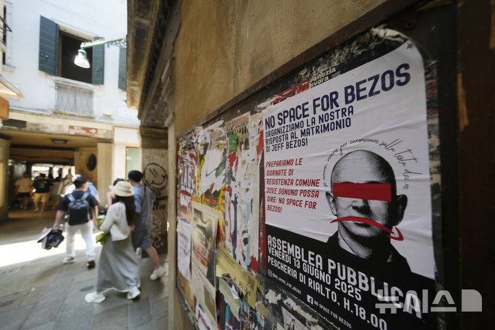 [베니스=AP/뉴시스] 지난 12일(현지 시간) 이탈리아 베니스의 한 건물 외벽에 아마존 창립자 제프 베이조스 초호화 결혼식을 비판하는 전단이 붙어 있다. 2025.06.26.