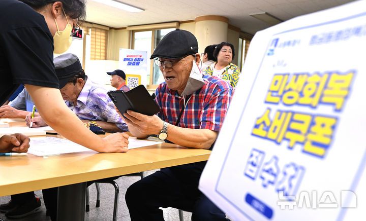 [수원=뉴시스] 김종택 기자 = 정부의 민생회복 소비쿠폰 1차 신청 첫날인 21일 경기 수원시 행궁동 행정복지센터에서 시민들이 지원금을 신청하고 있다. 소비쿠폰 신청은 요일제에 따라 출생 연도 끝자리 1·6은 월요일, 2·7은 화요일, 3·8은 수요일, 4·9는 목요일, 5·0은 금요일에 신청할 수 있다. 주말에는 온라인 신청만 가능하며 사용기한은 11월 30일까지다. 2025.07.21. jtk@newsis.com