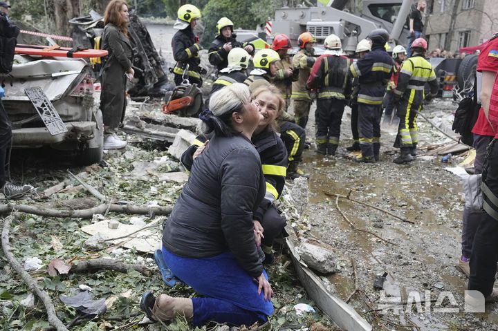[키이우=AP/뉴시스] 31일(현지 시간) 우크라이나 키이우에서 한 구조대원이 밤사이 발생한 러시아의 미사일 공격 현장에서 흐느끼는 주민을 위로하고 있다. 2025.07.31.