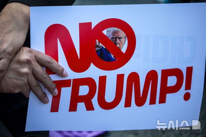 [서울=뉴시스] 정병혁 기자 = 25일 서울 중구 세종대로에서 열린 대미투자 전면 재검토 NO 트럼프 범시민대행진에서 참가자들이 피켓을 들고 있다. 2025.10.25 jhope@newsis.com