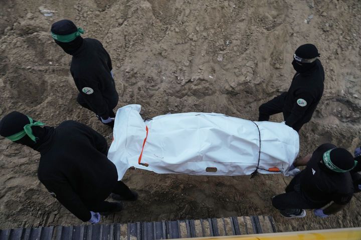 [칸유니스=AP/뉴시스] 28일(현지 시간) 가자지구 남부 칸유니스 하마드시티에서 하마스 대원들이 인질 유해 수색 중 터널에서 발견된 시신이 담긴 것으로 추정되는 백색 가방을 옮기고 있다.  2025.10.29.