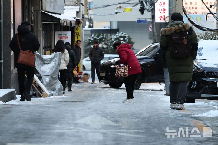 [서울=뉴시스] 권창회 기자 = 폭설 후 한파로 도로 곳곳이 얼어붙은 5일 오전 서울 중구 충무로역 인근에서 시민들이 빙판길을 조심히 걷고 있다. 2025.12.05. kch0523@newsis.com